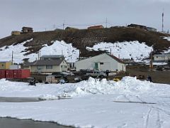 10A Buildings Next To Eclipse Sound Beach With Pond Inlet Sign On A Hill Behind Mittimatalik Baffin Island Nunavut Canada For Floe Edge Adventure